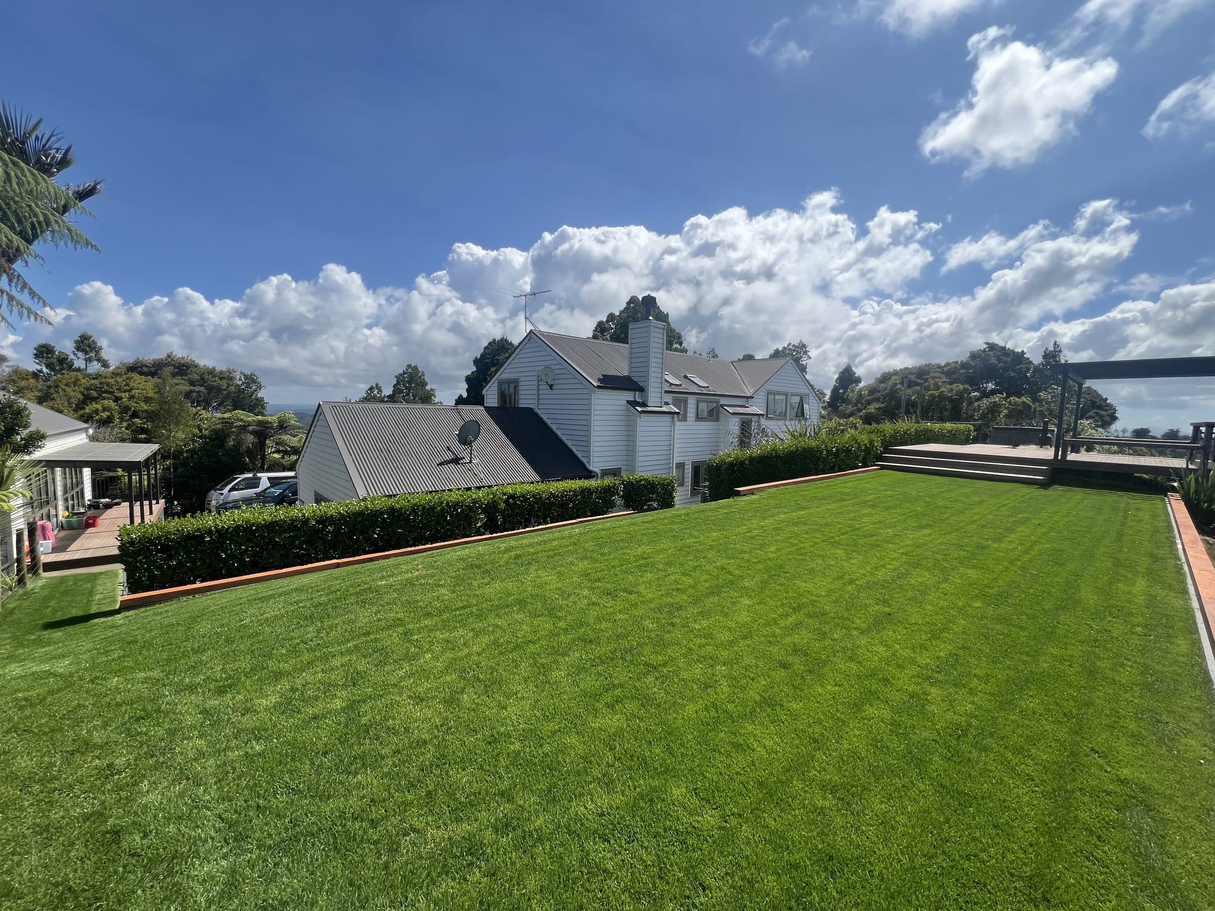 A large, freshly mown lawn beside a house